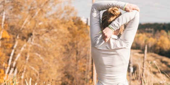 female in activewear stretching