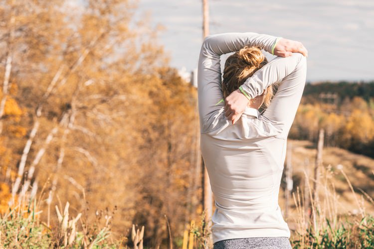 female in activewear stretching