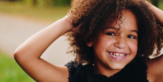 young girl with brown curly hair