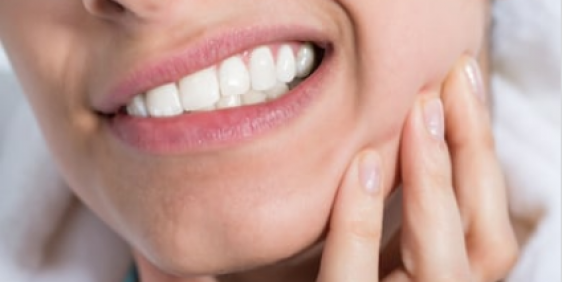 female showing her sensitive teeth