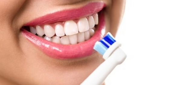 Oral B power brush used on female teeth
