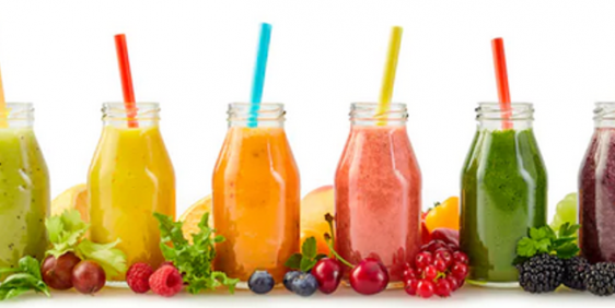 different flavoured smoothies with fruit on white background